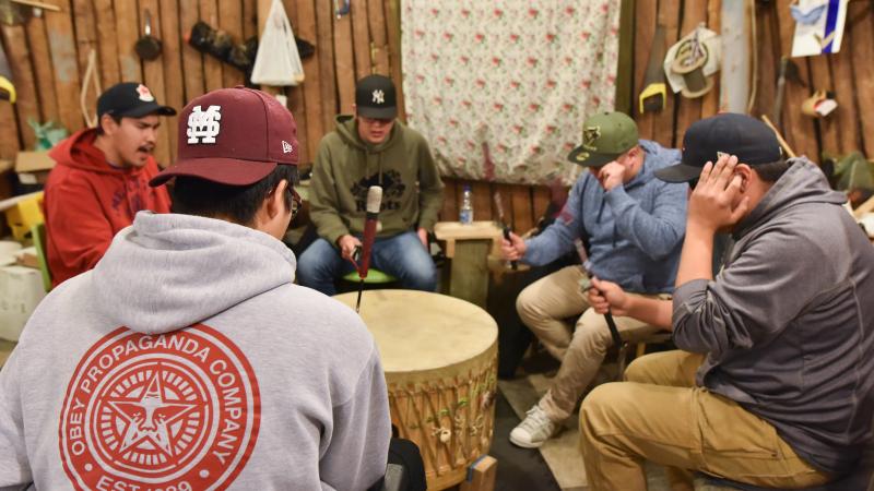 Drumming circle with one drummer shielding his ears