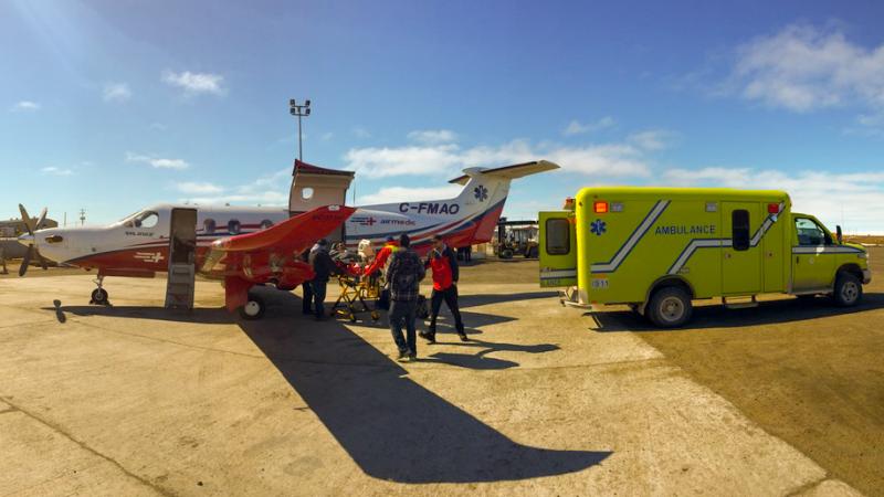 Patient being transferred from plane to ambulance