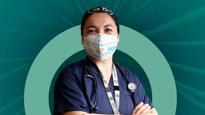 Nurse with mask standing in front of digital backdoor with flu campaign branding