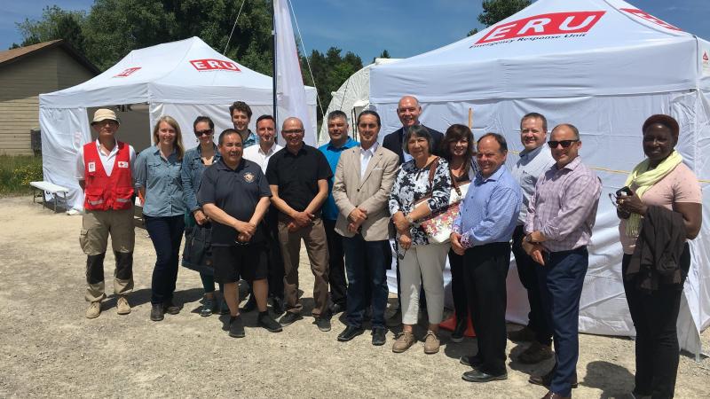 Representatives from Cree Nation of Chisasibi, Cree Health Board, and Red Cross stand in front of Emergency Response Unit equipment