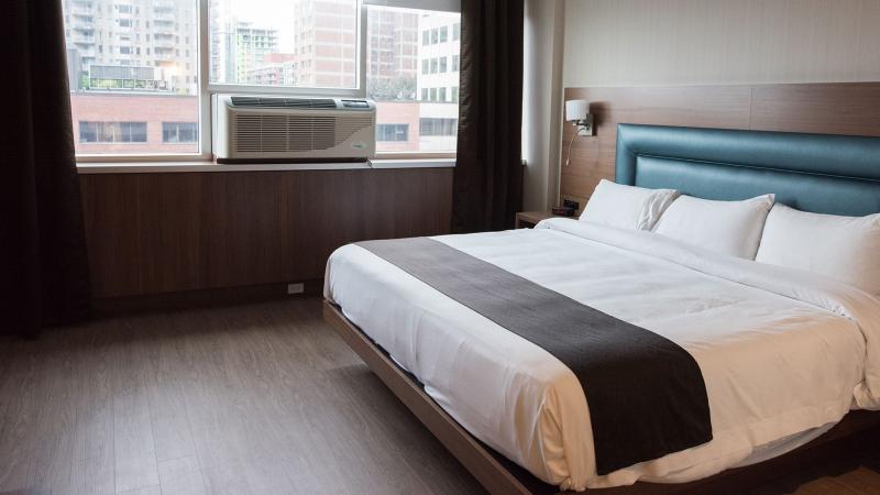 Interior of room at Espresso Hotel showing downtown Montreal in the background window 