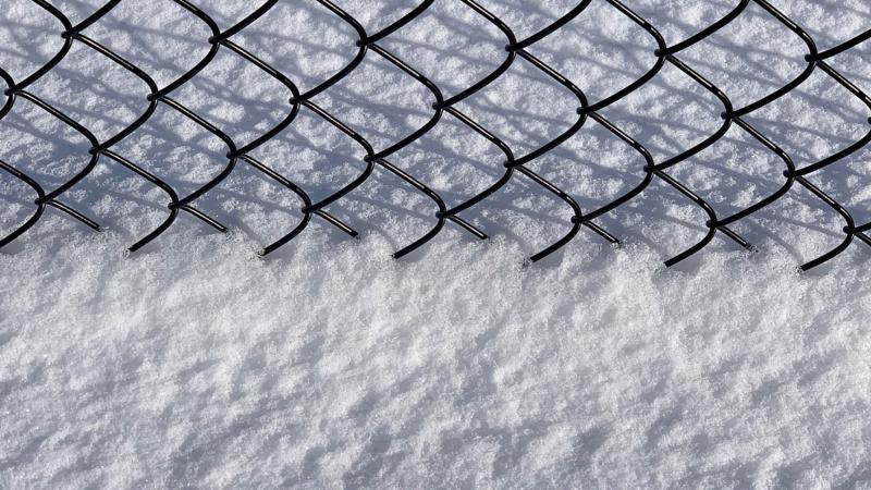 Closeup of chainlink fence and snow