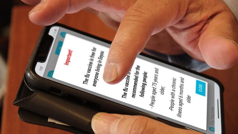 Closeup of hand navigating ClicSanté front page on cell phone