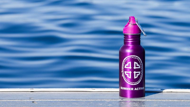 Summer Active water bottle on dock with lake in background