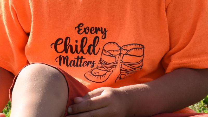 child wearing orange t-shirt