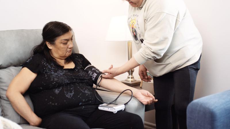 Woman in chair gets her blood pressure checked