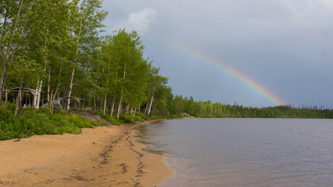 Beach and lake with rainbow in the background