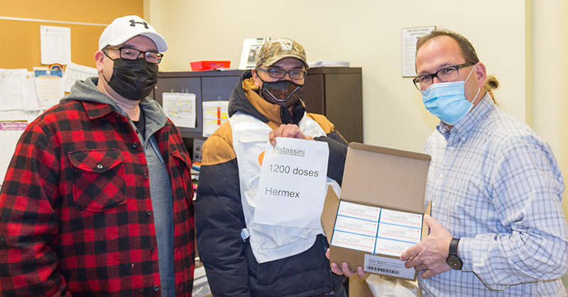 Richard Shecapio and Jason Coonishish deliver vaccines to Martin Nyles, Head of Current Services, Mistissini CMC.