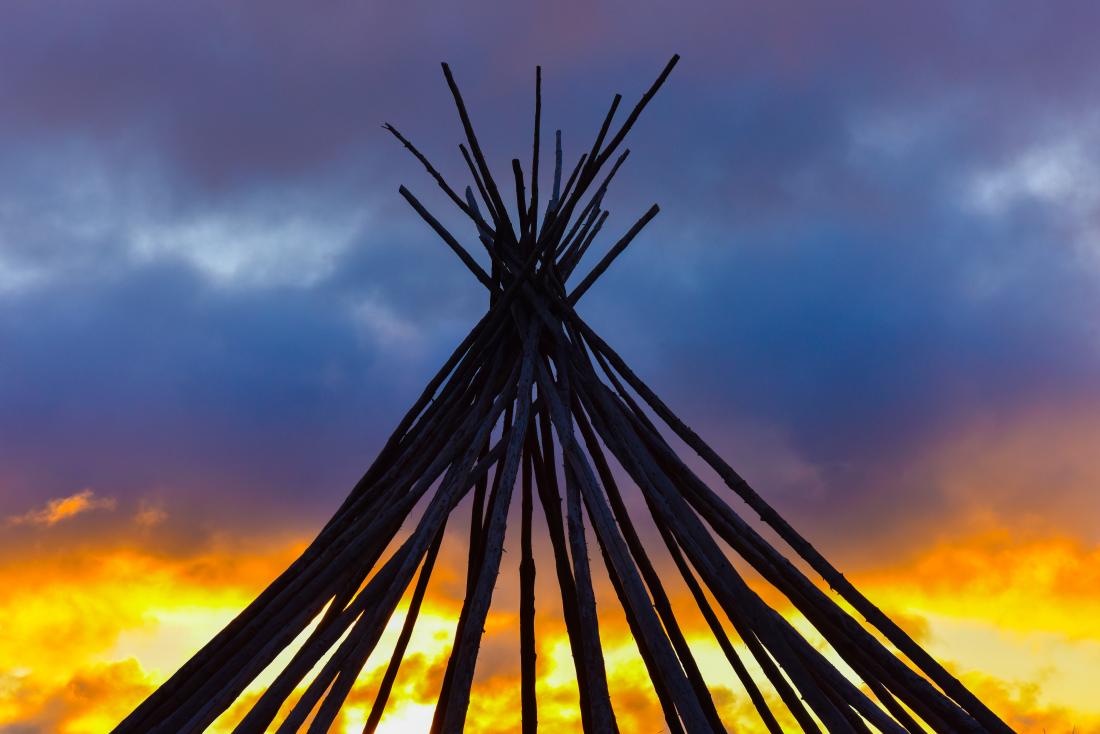 A teepee with a sunset backdrop