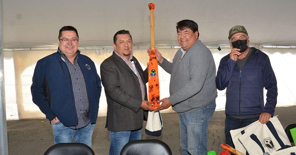 CHB Chairperson Bertie Wapachee receives gift of a paddle from Waswanipi Chief and Deputy Chief