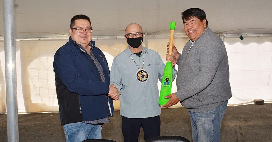 Jason Coonishish receives gift of a paddle from Waswanipi Chief and Deputy Chief
