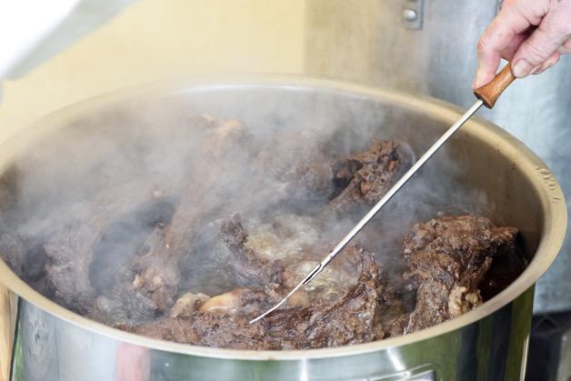 Meat in a pot being stirred