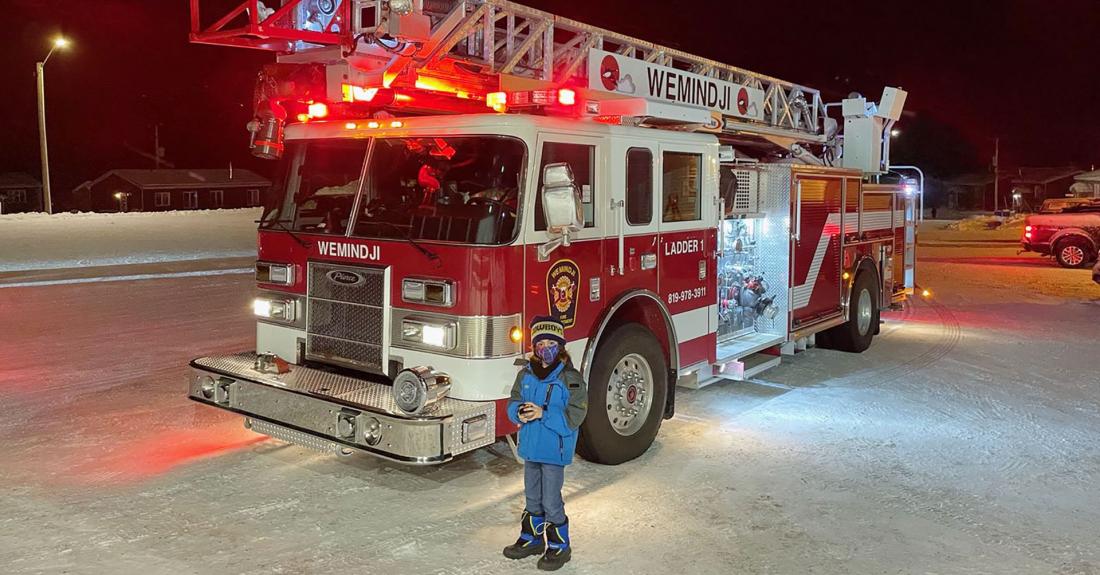 Child stands in front of Wemindji fire truck