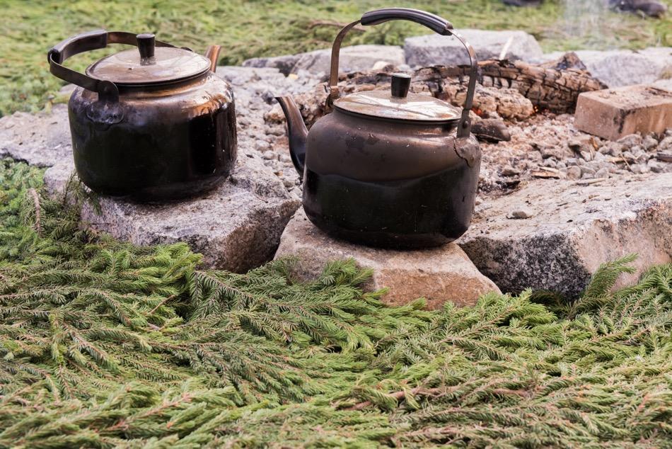 2 teapots on rocks in a teepee