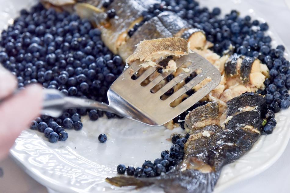 Fish and blueberries on a plate