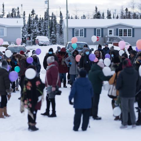 Mourners holding balloons