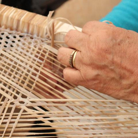 Closeup of woman weaving snowshoe