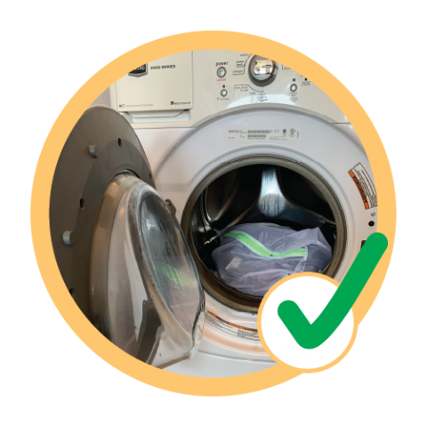 Clothes in clothes dryer with check mark