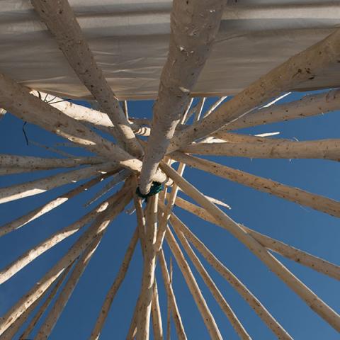 View of sky through opening in teepee