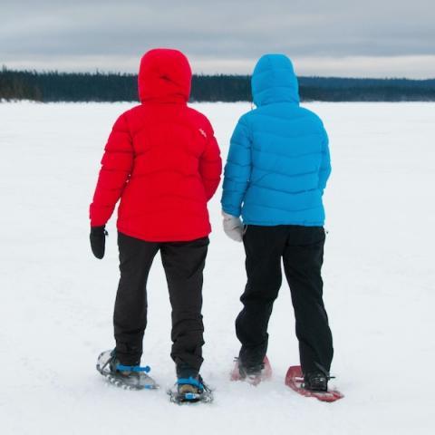 2 people snowshoeing on frozen lake