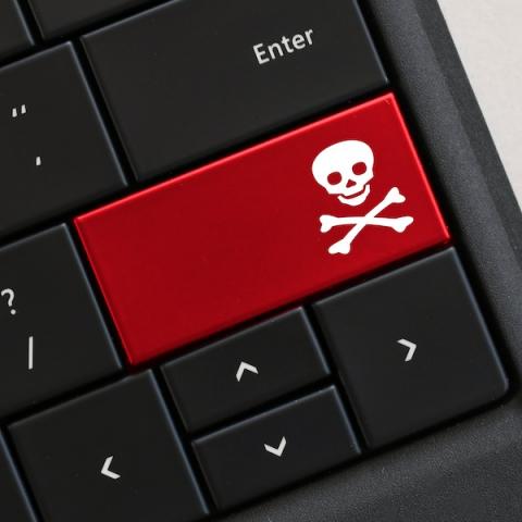 Computer keyboard with red poison symbol