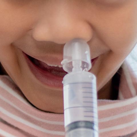 Child using nose syringe