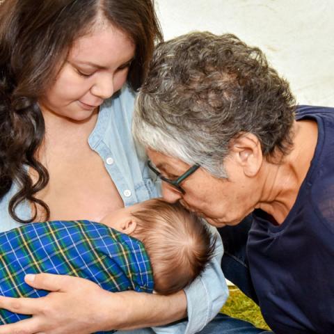 Mother and grandmother with baby who is breastfeeding